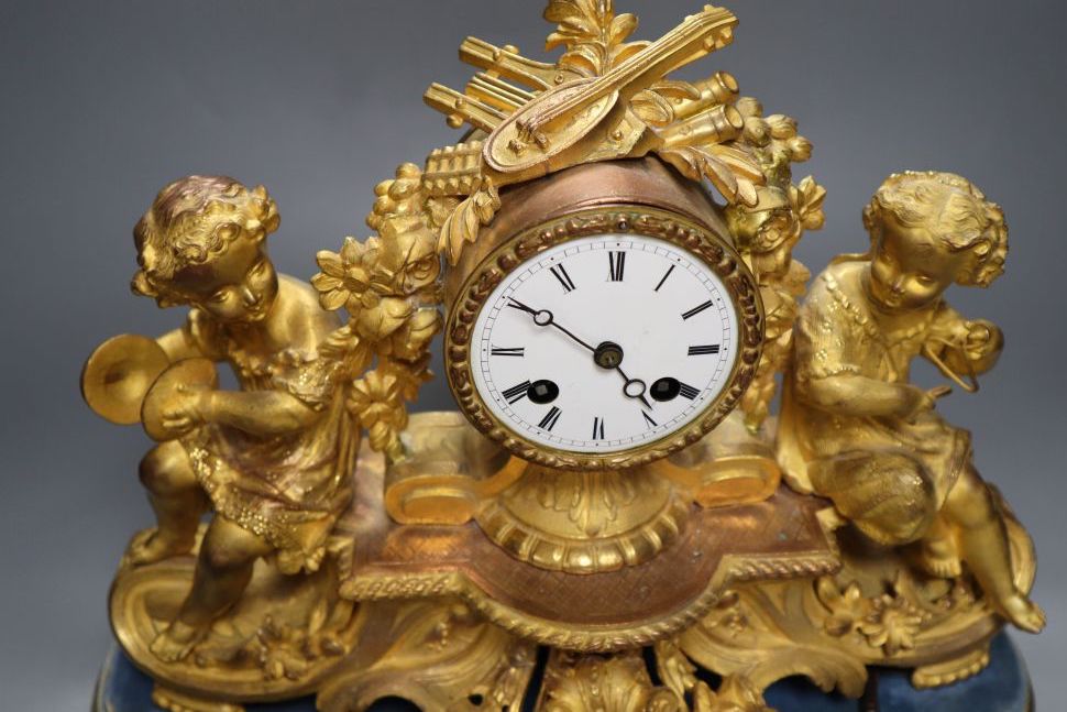 A 19th century French ormolu and gilt metal mantel clock, with musical youth surmount, Vincenti bell striking movement, on giltwood pli